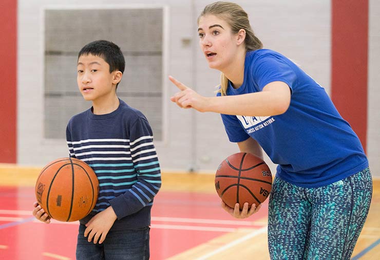 A child with autism and a support worker in our I CAN Play Sports program