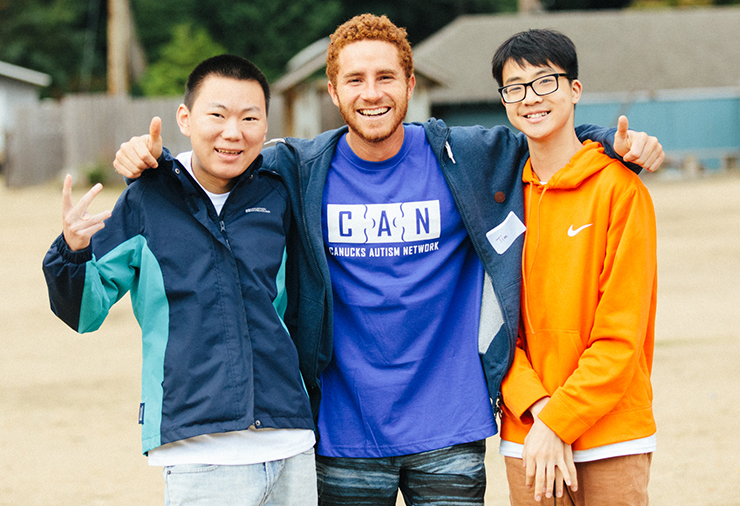 Three young adults enjoy having fun outdoors.