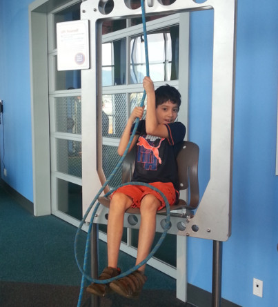 A child sits in an interactive exhibit at Science World.