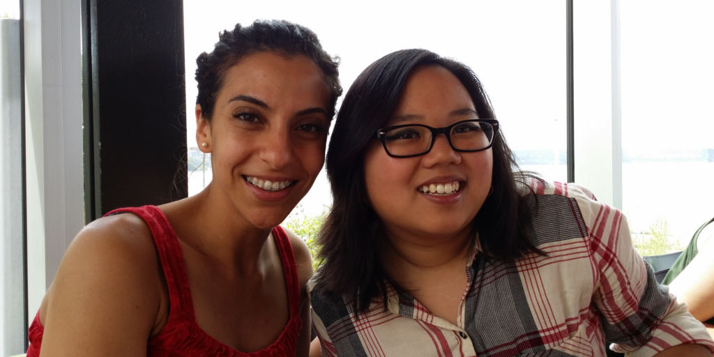 Two young adult women pose for a photo together.