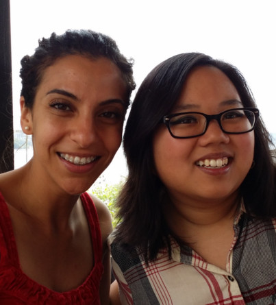 Two young adult women pose for a photo together.