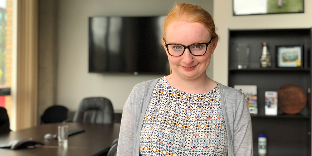 A young adult woman in an office