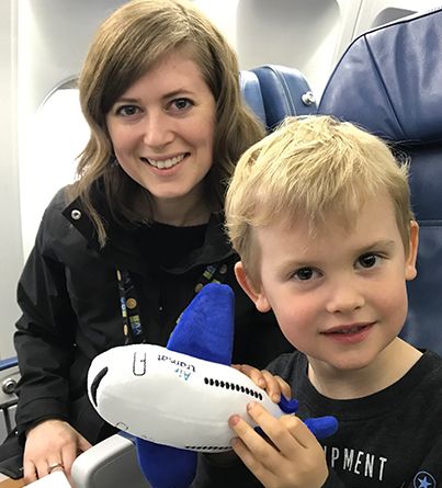 A mother and child seated in an airplane.